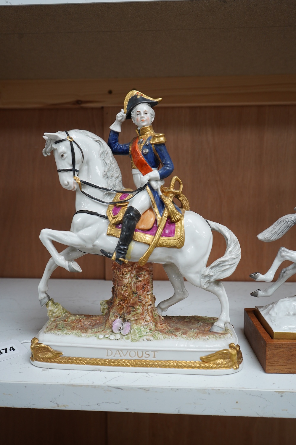 A group of three continental porcelain models of riders on horseback, tallest 27cm